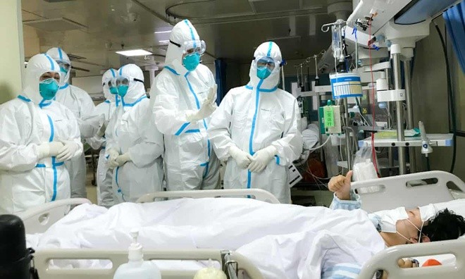 Các bác sĩ tại thành phố Vũ Hán đang chăm sóc cho một bệnh nhân nhiễm virus corona. Ảnh: REX.